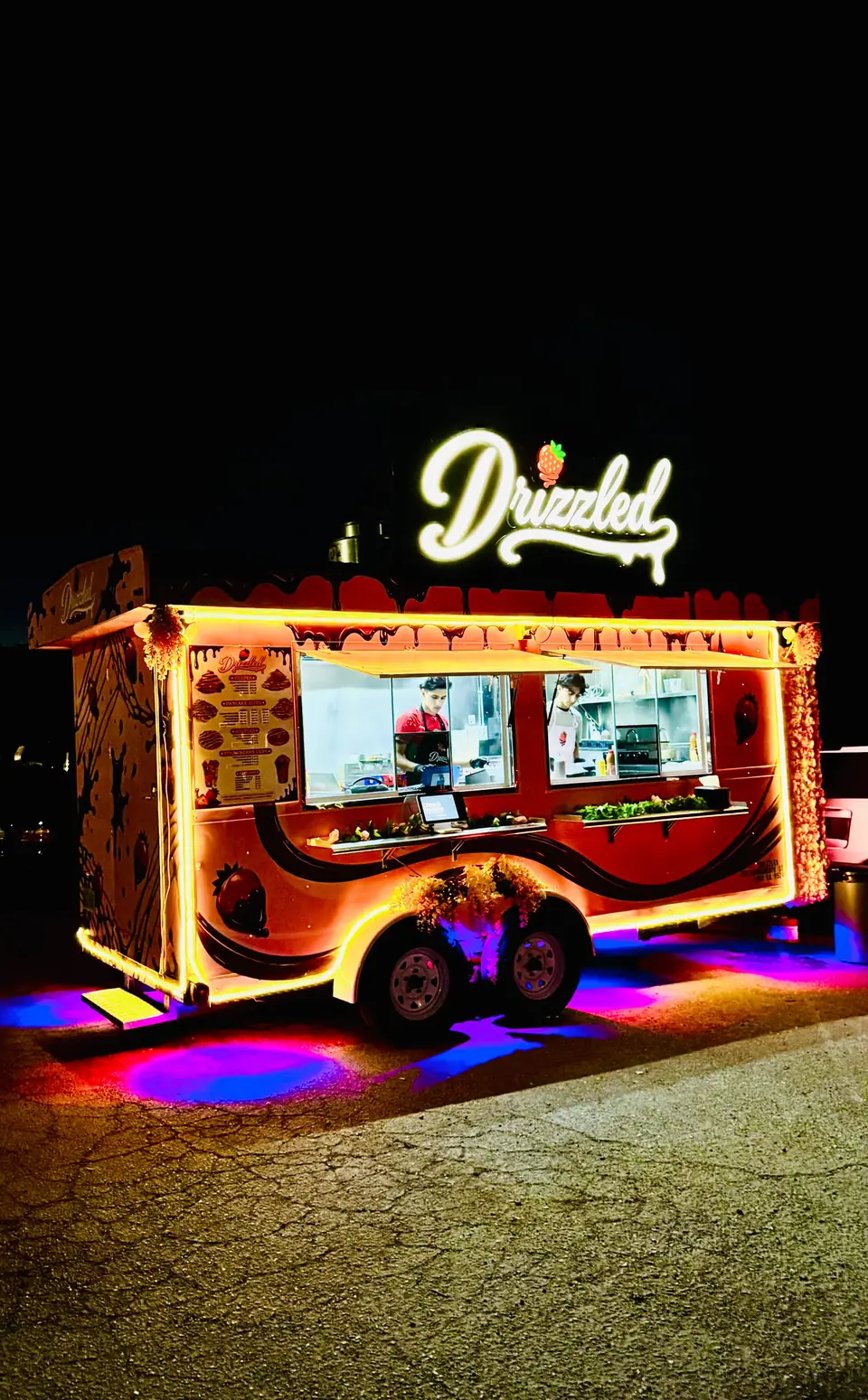 Drizzled dessert trailer lit up at night on Davis Road in Stockton, California